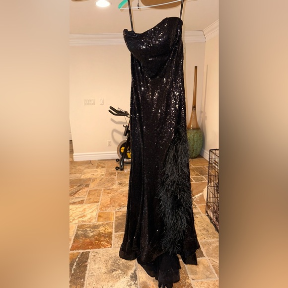 Black sequence and feather detailed Sherri Hill gown. - Picture 2 of 4